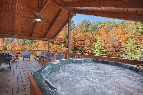 A hot tub on the deck of a Smoky Mountain cabin rental.