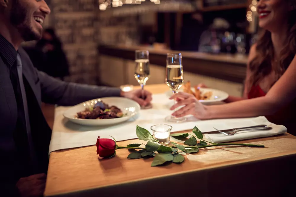 happy couple having dinner in romantic restaurant